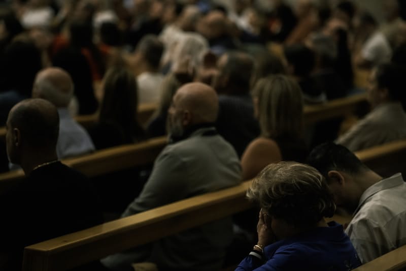 Worshippers in prayer at bonfire gathering